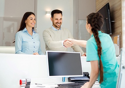 Man shaking receptionist’s hand