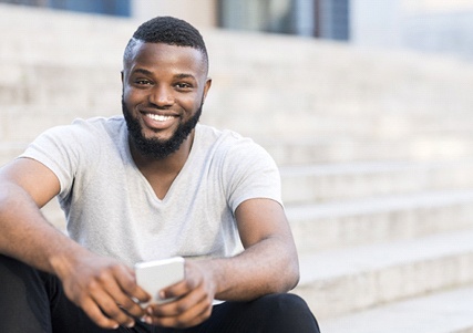 person holding their phone and smiling