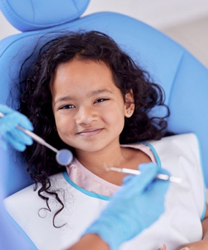 Girl smiling while seeing a Medicaid dentist in Saginaw 