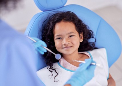 Girl having her teeth checked at the dentist’s office 