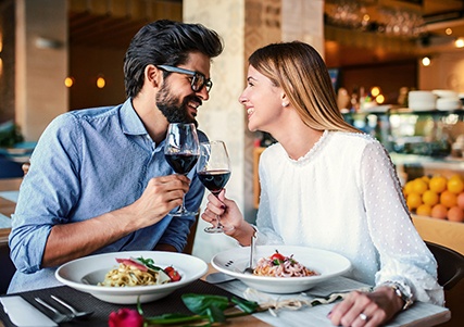 Couple smiling at each other on date in restaurant