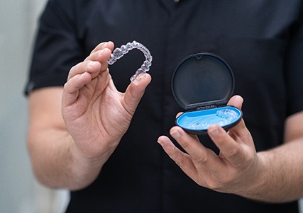 Patient holding clear aligner