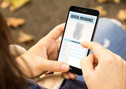Patient looking at dental insurance form on phone