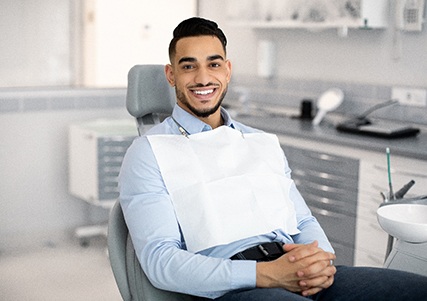Smiling patient sitting in treatment chair