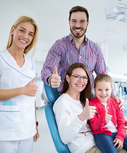 Family smiling after fluoride treatments from dentist