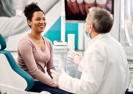 woman talking to cosmetic dentist in Saginaw