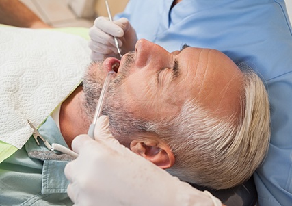 Man receiving preventive care at the dentist’s office