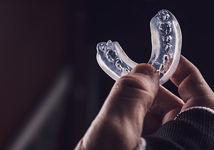 Close-up of hand holding mouthguard