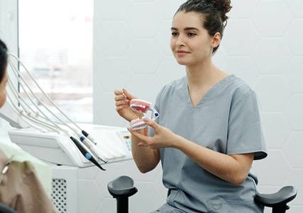 Dentist giving patient consultation for dental implants