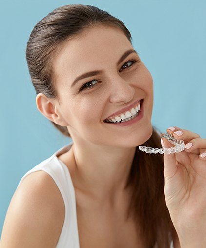 Woman placing a clear alignment tray