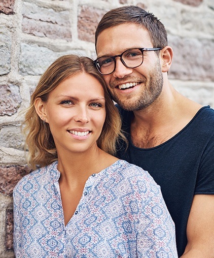 Smiling man and woman outdoors