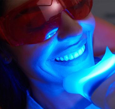 a patient undergoing professional teeth whitening treatment