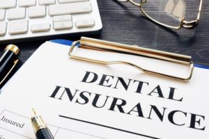 dental insurance on clipboard outlining coverage