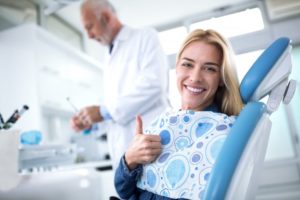 smiling woman getting fillings from her dentist