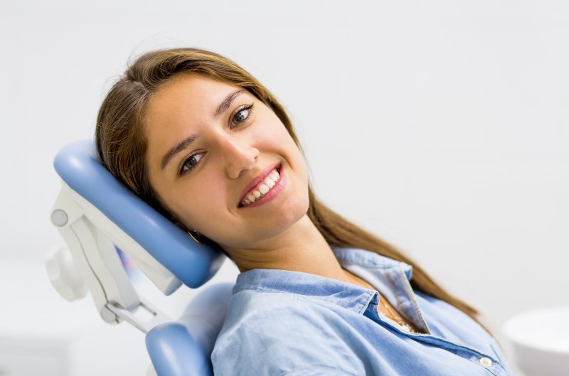 Young woman smiling in dental chair after root canal