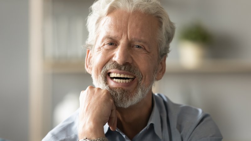 person wearing dentures and smiling